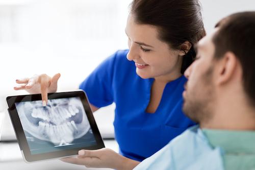 Dentist in Brandon, FL showing patient a dental x-ray