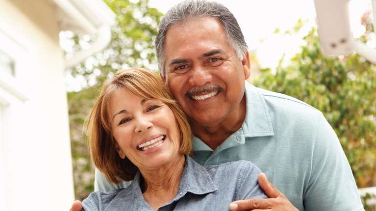 Couple with denture implants smiling in Brandon, FL