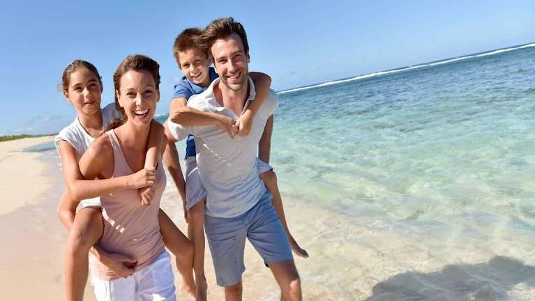 A smiling family at the beach | dentist Brandon, FL