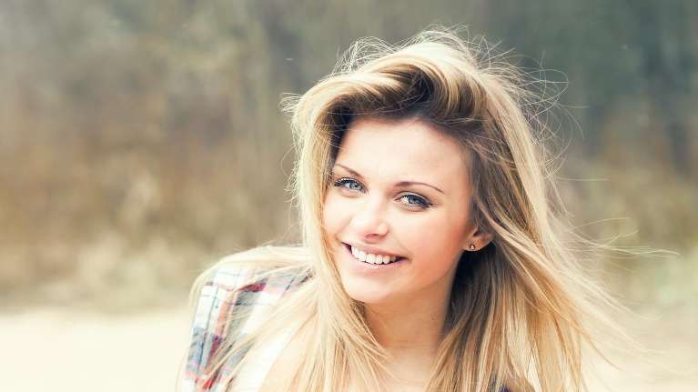 A smiling woman outside | Invisalign in Brandon, FL