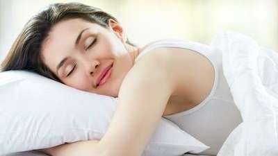 A woman happily sleeping