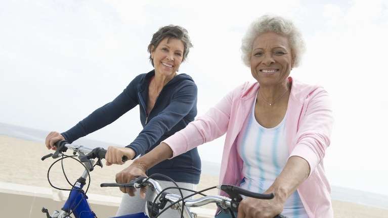 Two women riding bikes