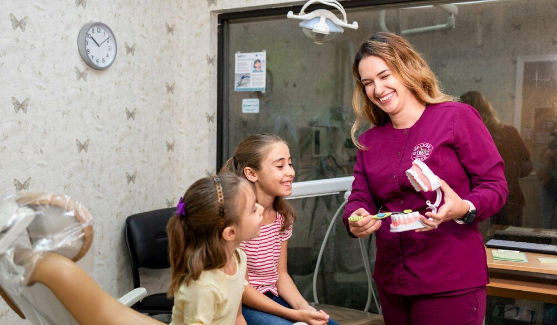 Dentist in Brandon, FL showing kids how to brush teeth