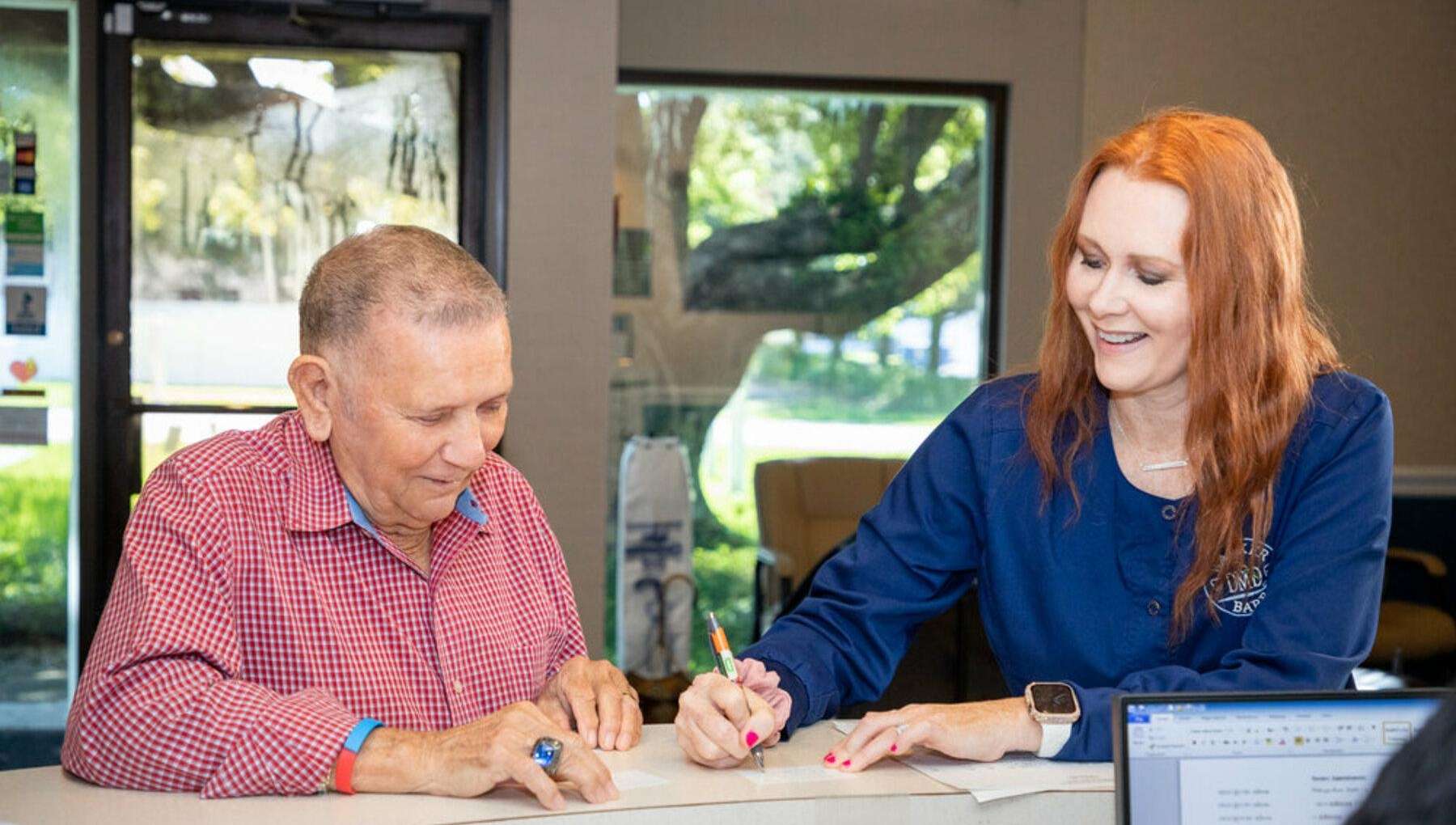 Patient at front desk at dentist office in Brandon, FL