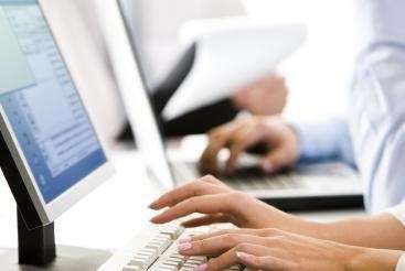 Dentist in Brandon, FL typing digital records on a computer