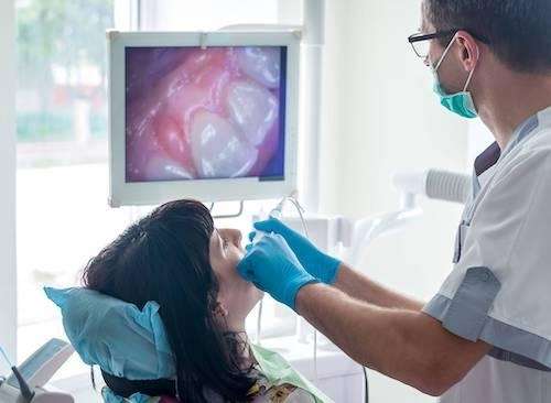 Dentist in Brandon, FL using intraoral camera on patients teeth